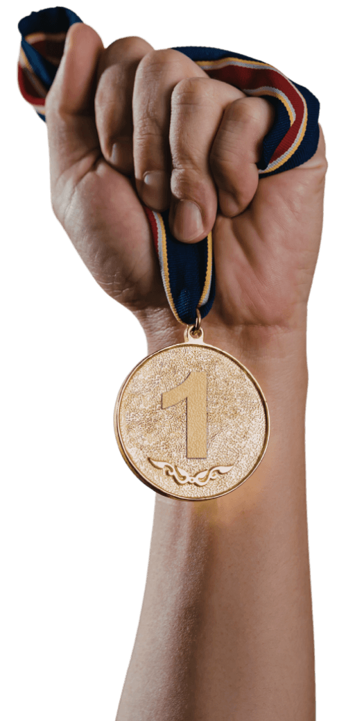 Hand holding gold medal